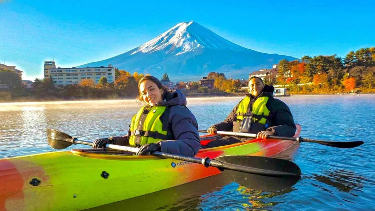 A kayak on glassy early-morning Lake Kawaguchi with Mount Fuji reflected in the water on a guided kayak tour, Fujikawaguchiko, Japan